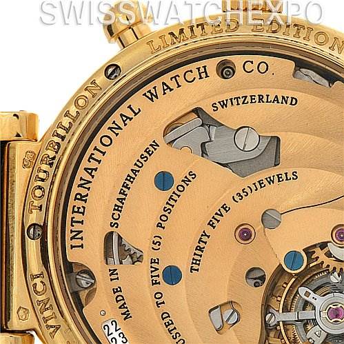 The image shows a close-up of the back of an IWC Da Vinci IW375203 OR 3752-03 OR 3752-003 Men's Yellow Gold Silver Dial IW375203 OR 3752-03 OR 3752-003 Men's Yellow Gold Silver Dial Tourbillon watch, revealing intricate mechanical parts and engraving.