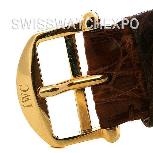 This image shows a close-up of the gold buckle and brown leather strap of the Da Vinci model watch by IWC.