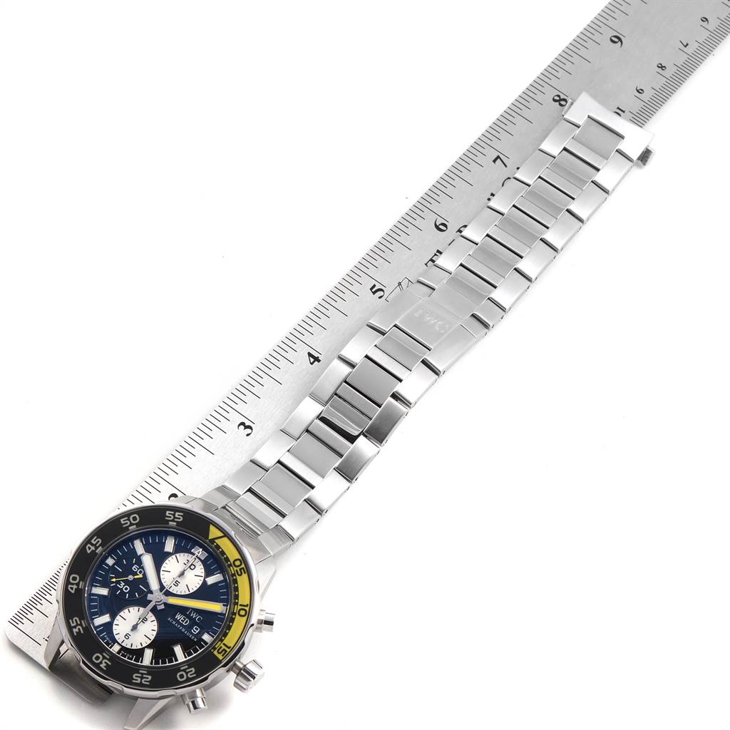 The IWC Aquatimer IW376701 Men's Stainless Steel Black Dial IW376701 Men's Stainless Steel Black Dial watch is shown from an overhead angle, displaying the face, band, and a ruler for scale.