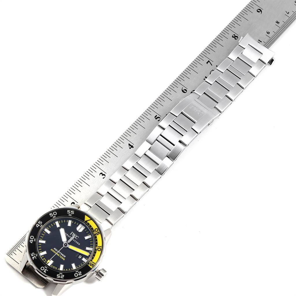 The image shows an IWC Aquatimer IW356801 Men's Stainless Steel Black Dial IW356801 Men's Stainless Steel Black Dial watch laid flat with its stainless steel bracelet measured against a ruler.