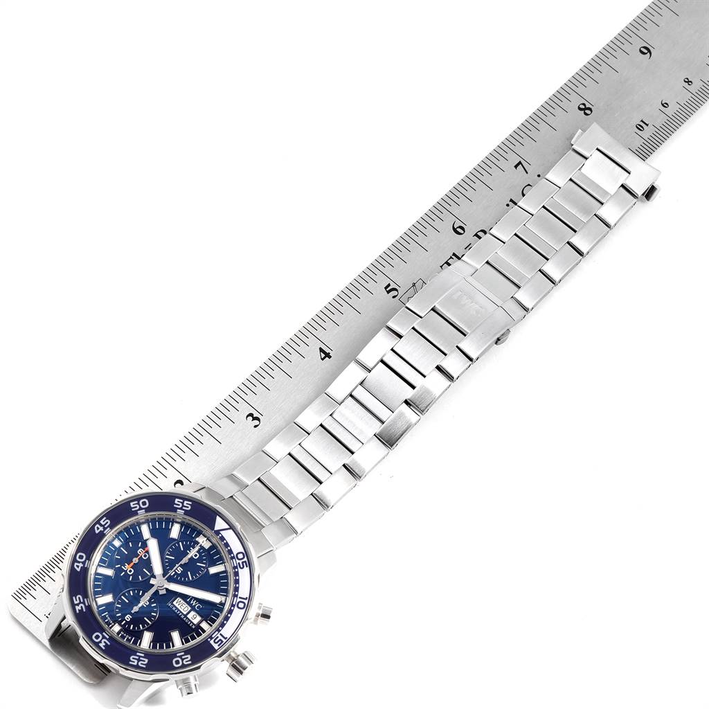 The IWC Aquatimer IW376710 Men's Stainless Steel Blue Dial IW376710 Men's Stainless Steel Blue Dial watch is displayed flat with its stainless steel bracelet fully extended next to a ruler for scale.