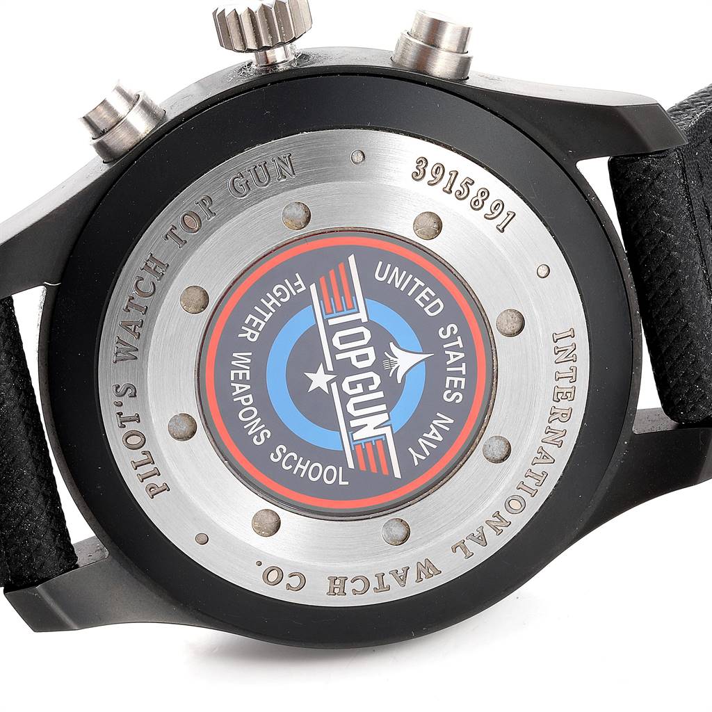 The image shows the back case of the IWC Pilot IW388001 Men
s Titanium Black Dial IW388001 Men
s Titanium Black Dial model watch, highlighting the "Top Gun" and "United States Navy Fighter Weapons School" emblem.