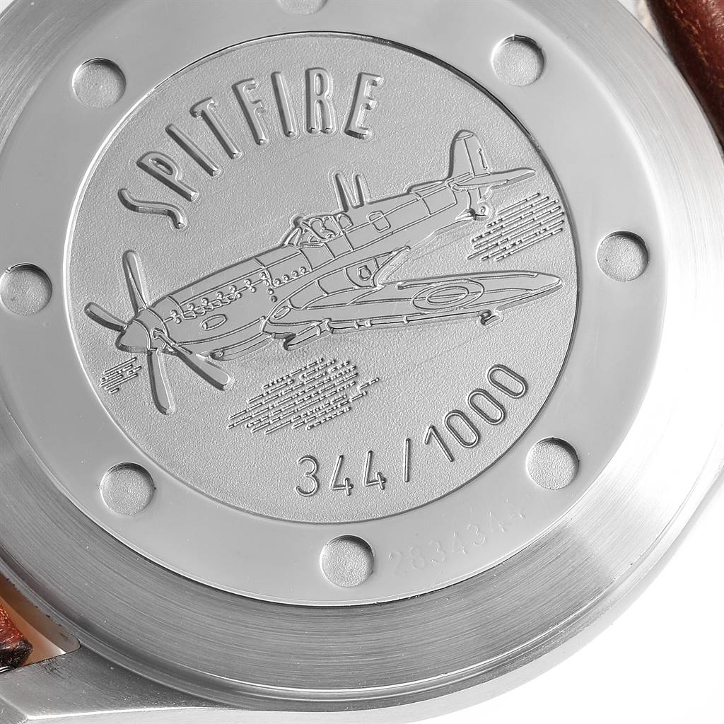 The image shows the back case of an IWC Pilot IW3253005 Men's Stainless Steel Black Dial IW3253005 Men's Stainless Steel Black Dial model watch, featuring an engraved Spitfire aeroplane.