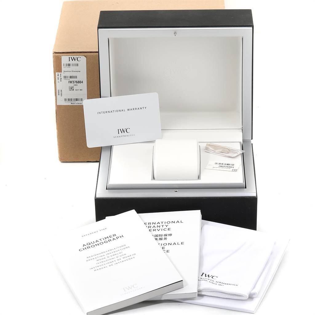 The image shows an IWC Aquatimer IW376804 Men's Stainless Steel Black Dial IW376804 Men's Stainless Steel Black Dial watch box, warranty card, manuals, and cleaning cloth from a front angle.
