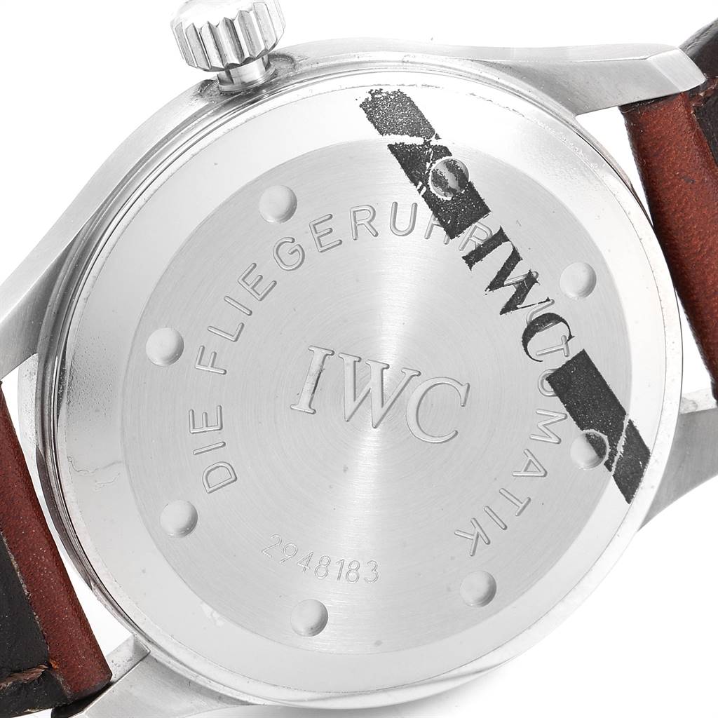 The image shows the back side of an IWC Pilot IW325313 Men's Stainless Steel Silver Dial IW325313 Men's Stainless Steel Silver Dial watch, highlighting the stainless steel case, engraved text, and leather strap attachment.