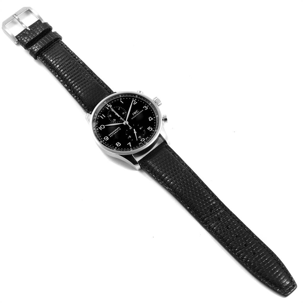The image shows an IWC Portuguese IW371438 Men's Stainless Steel Black Dial IW371438 Men's Stainless Steel Black Dial model watch from a top-down angle, featuring the black dial, case, and leather strap.