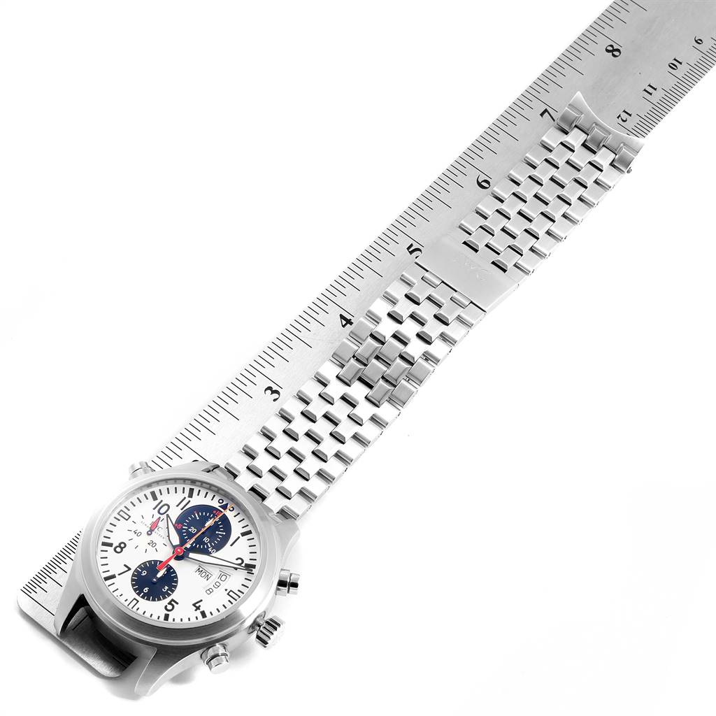 The image shows an IWC Pilot IW371803 Men's Stainless Steel White Dial IW371803 Men's Stainless Steel White Dial model watch laid flat with its stainless steel band extended and measured with a ruler.