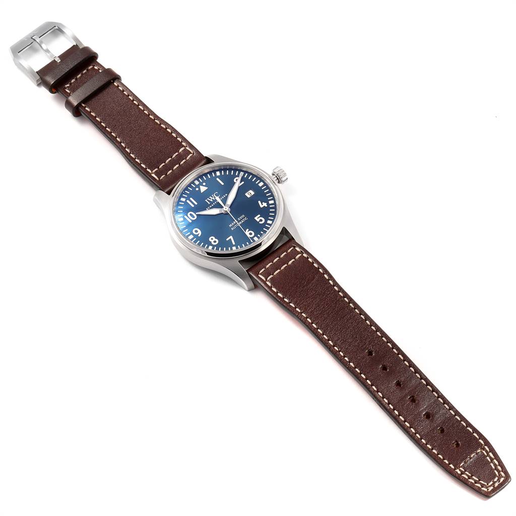 The IWC Pilot IW327004 Men's Stainless Steel Blue Dial IW327004 Men's Stainless Steel Blue Dial watch is shown from a top-down angle displaying its blue dial, brown leather strap, and silver buckle.