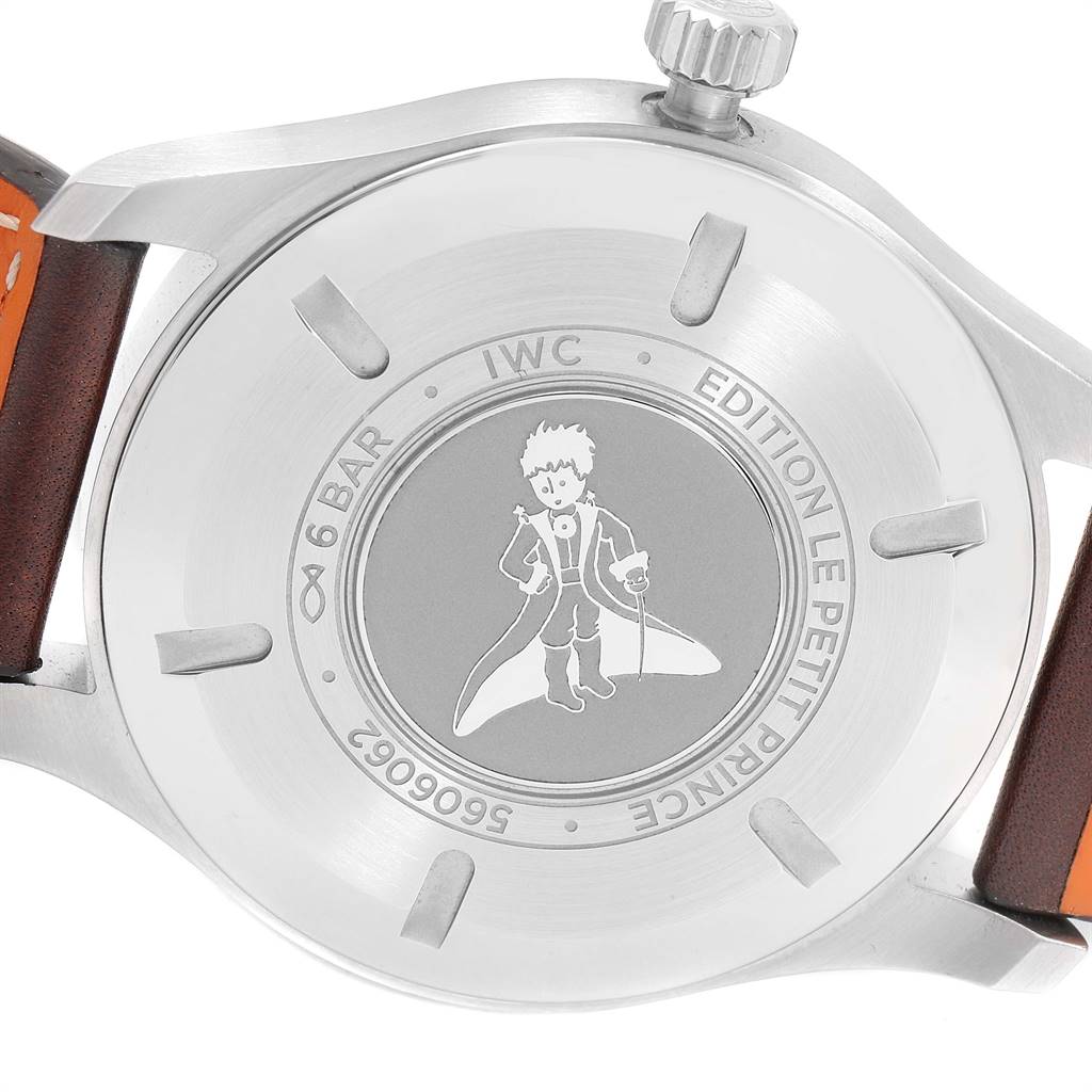 The image shows the back case of an IWC Pilot IW327004 Men's Stainless Steel Blue Dial IW327004 Men's Stainless Steel Blue Dial "Le Petit Prince" watch, including the crown and part of the leather strap.