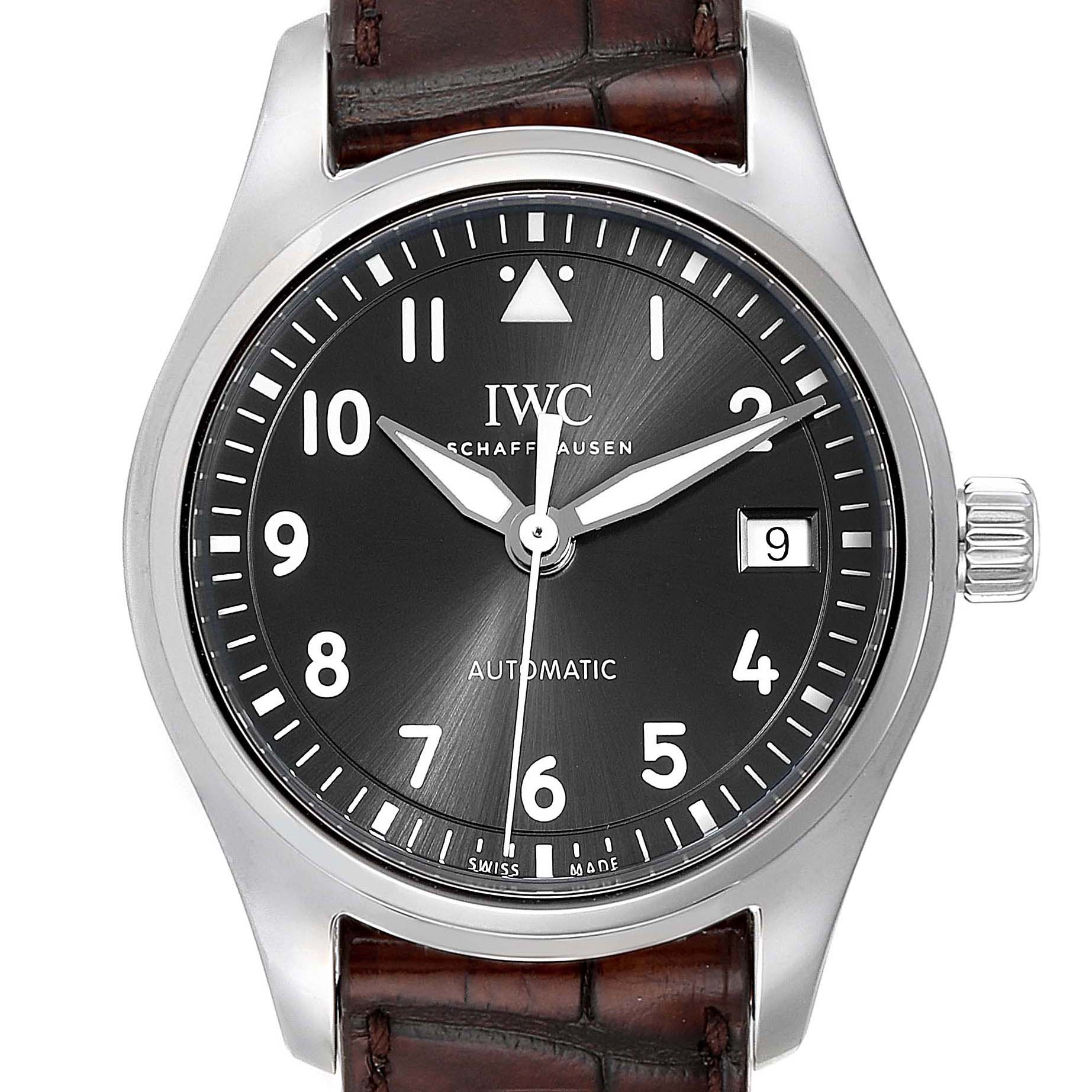 This image shows the full face of an IWC Pilot 5524G Men
s Stainless Steel Grey Dial 5524G Men
s Stainless Steel Grey Dial model watch, displaying its dial, hands, crown, and part of its leather strap.