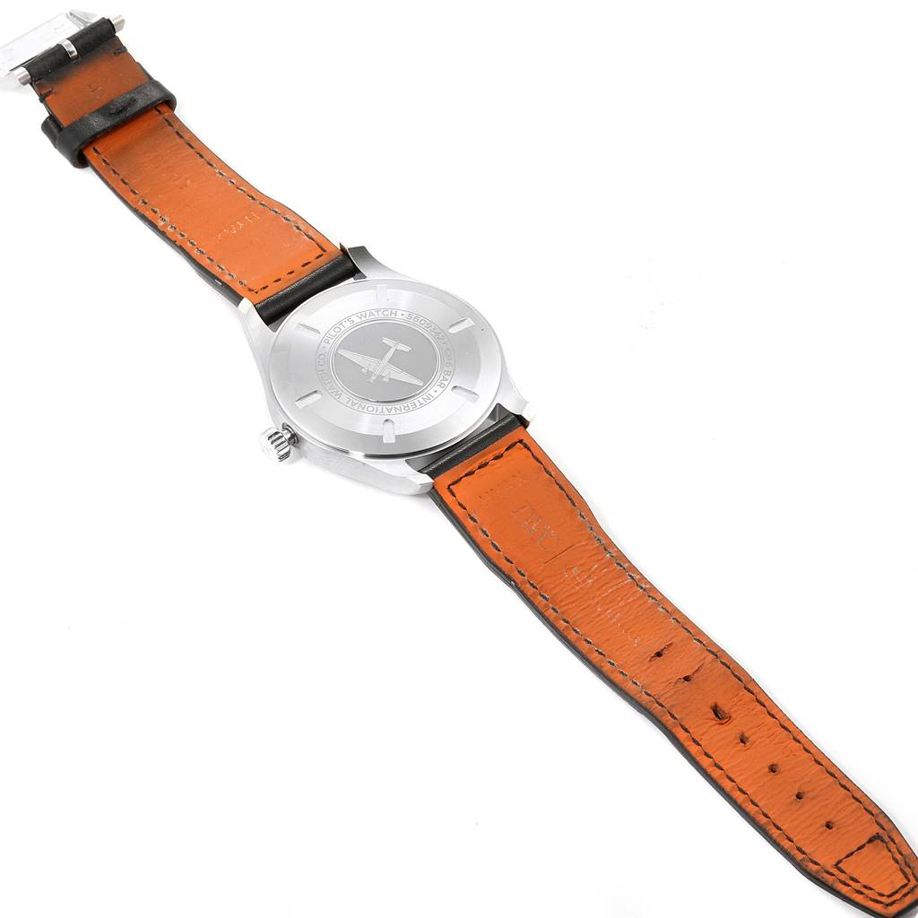 The image shows the back view of an IWC Pilot IW327001 Men's Stainless Steel Black Dial IW327001 Men's Stainless Steel Black Dial model watch, highlighting the case back and orange leather strap.