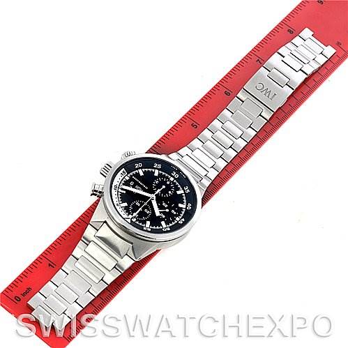 The image shows an IWC Aquatimer IW371928 Men's Stainless Steel Black Dial IW371928 Men's Stainless Steel Black Dial watch from a top-down angle, with its stainless steel bracelet extended along a red ruler.