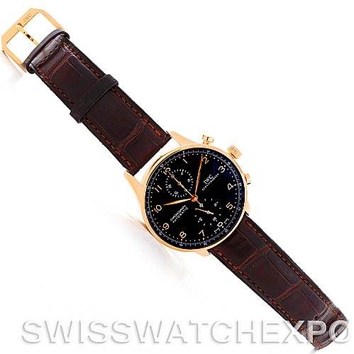 The image shows an IWC Portuguese IW3714-15 Men's Rose Gold Black Dial IW3714-15 Men's Rose Gold Black Dial model watch with a brown leather strap and gold case at a top-down angle.