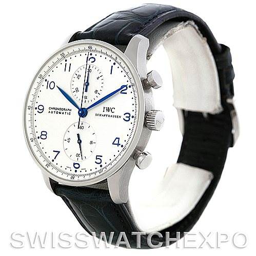 The image shows a side angle of an IWC Portuguese IW371417 Men
s Stainless Steel Silver Dial IW371417 Men
s Stainless Steel Silver Dial watch, featuring its white dial, blue hands, and black leather strap.