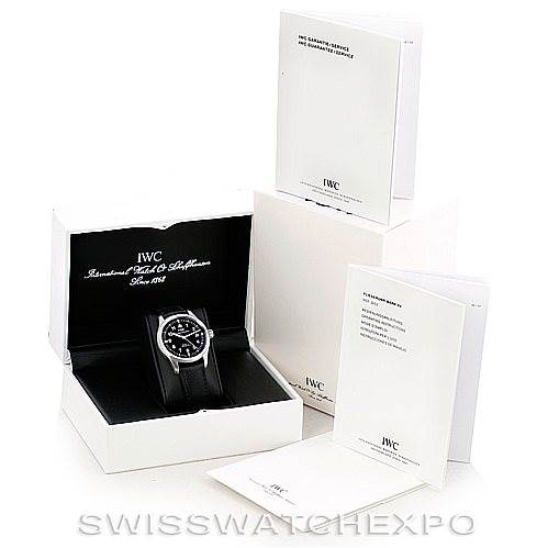 The image shows an IWC Pilot IW325301 Men's Stainless Steel Black Dial IW325301 Men's Stainless Steel Black Dial model watch at an angled view in its open box with surrounding packaging and booklets.
