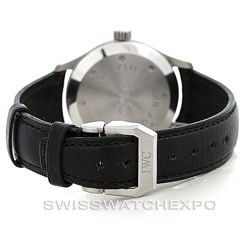 The image shows the back of an IWC Pilot MARK XII Men's Stainless Steel Black Dial MARK XII Men's Stainless Steel Black Dial watch, focusing on the leather strap and the clasp with the IWC logo engraved on it.