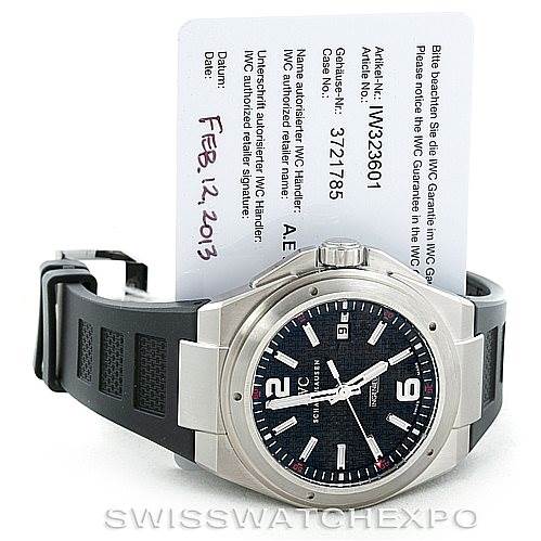 The IWC Ingenieur IW323601 Men's Stainless Steel Black Dial IW323601 Men's Stainless Steel Black Dial watch is shown from a front angle, displaying its dial, bezel, and part of the strap, along with a certificate card.