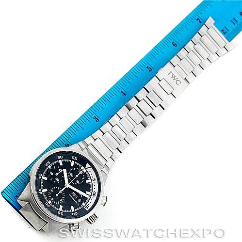 The IWC Aquatimer IW371928 Men's Stainless Steel Black Dial IW371928 Men's Stainless Steel Black Dial watch is shown from a top-down angle, displaying the face, bezel, and metal bracelet alongside a blue ruler.
