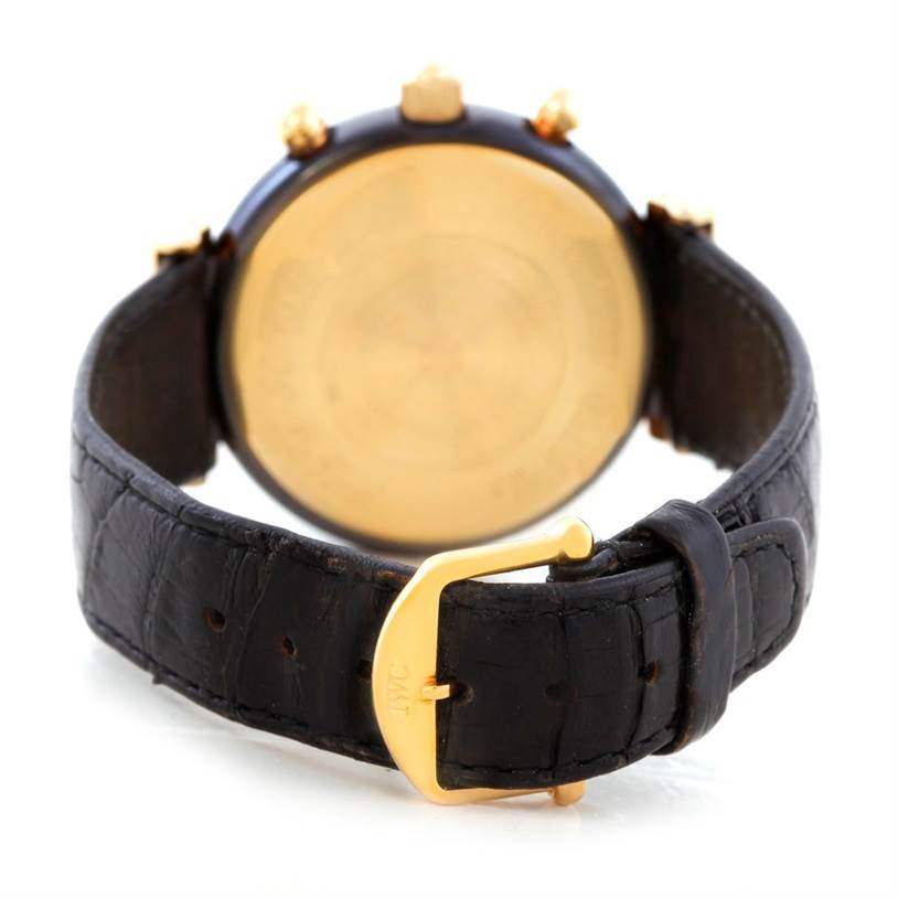 This image shows the back of an IWC Da Vinci 3755 Men's Yellow Gold White Dial 3755 Men's Yellow Gold White Dial watch, including its case back, crown, and leather strap with a gold buckle.