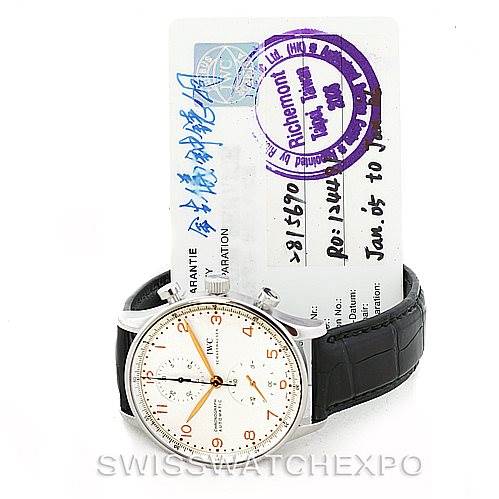 The image shows an IWC Portuguese IW371445 Men's Stainless Steel Silver Dial IW371445 Men's Stainless Steel Silver Dial model watch with a leather strap and a warranty card in the background.