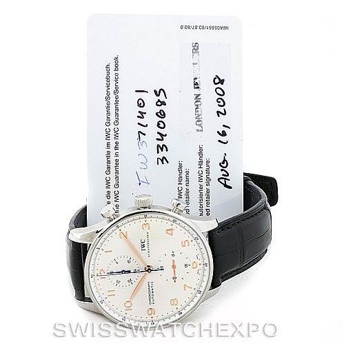 The image shows an IWC Portuguese IW371401 Men
s Stainless Steel Silver Dial IW371401 Men
s Stainless Steel Silver Dial model watch with a black leather strap and warranty card from a front angle.