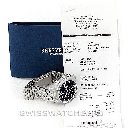 The image shows an IWC Pilot IW370607 Men's Stainless Steel Black Dial IW370607 Men's Stainless Steel Black Dial model watch at an oblique angle, featuring its bracelet and the face, along with the box and a sales receipt.