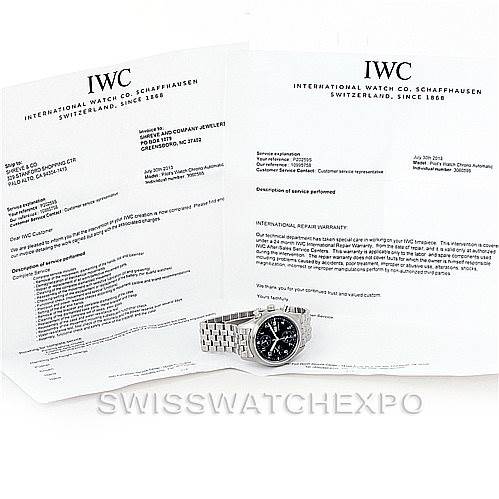 The image shows an IWC Pilot IW370607 Men's Stainless Steel Black Dial IW370607 Men's Stainless Steel Black Dial model watch at an angle, along with its warranty and paperwork.