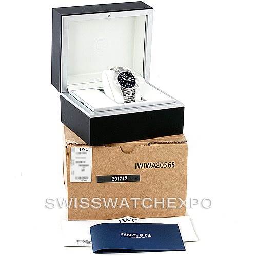 The image shows an IWC Pilot IW370607 Men's Stainless Steel Black Dial IW370607 Men's Stainless Steel Black Dial model watch in its open box, along with a cardboard box, warranty card, and booklet.