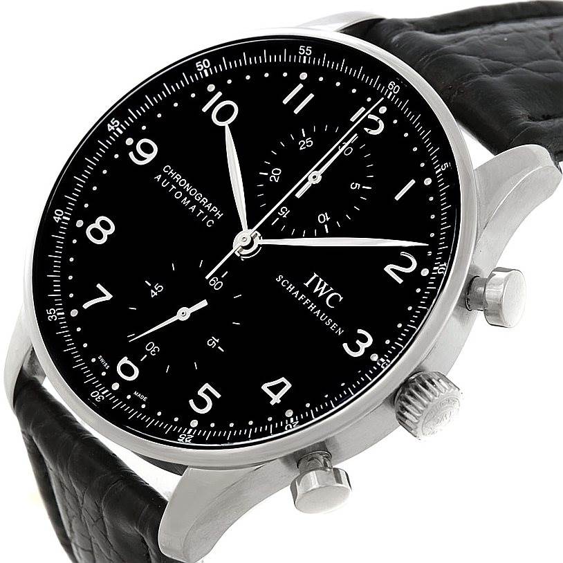 The image shows an IWC Portuguese IW371438 Men
s Stainless Steel Black Dial IW371438 Men
s Stainless Steel Black Dial Chronograph watch at a slight angle, highlighting the black dial, numeral markers, crown, and pushers.