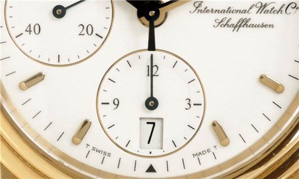 Close-up of the dial of a Vintage IWC watch showing subdials, date window, hands, and brand inscription.