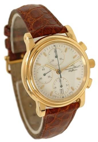 This image shows an oblique front view of a vintage IWC watch, highlighting its gold case, white dial, and brown leather strap.