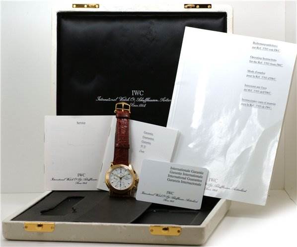 The image shows an IWC Vintage 3703 Men's Yellow Gold White Dial 3703 Men's Yellow Gold White Dial model watch with a brown leather strap, displayed with its box, manuals, and guarantee documents.