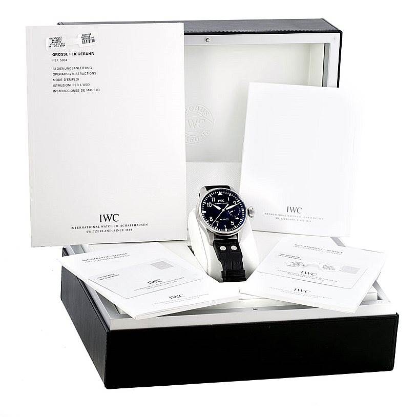 This image shows an IWC Pilot IW500401 Men's Stainless Steel Black Dial IW500401 Men's Stainless Steel Black Dial watch in its open box, surrounded by manuals and documentation.