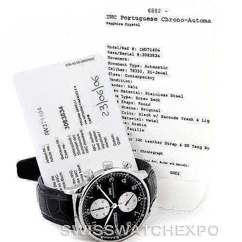 The image shows an IWC Portuguese IW371404 Men
s Stainless Steel Black Dial IW371404 Men
s Stainless Steel Black Dial Chrono-Automatic watch at an angle displaying its face and side, along with its documentation and warranty card.