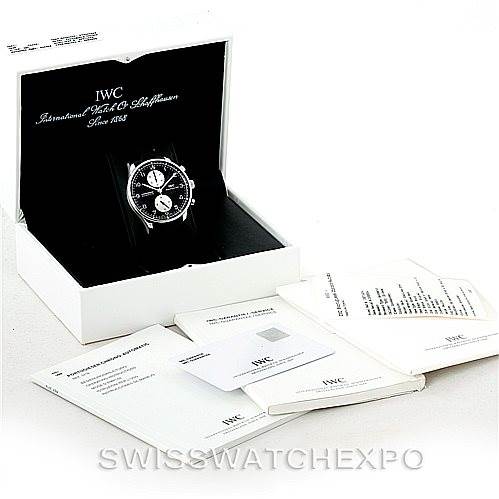 The image shows an IWC Portuguese IW371404 Men
s Stainless Steel Black Dial IW371404 Men
s Stainless Steel Black Dial model watch in its box with accompanying manuals and documents, at a slight angle from above.