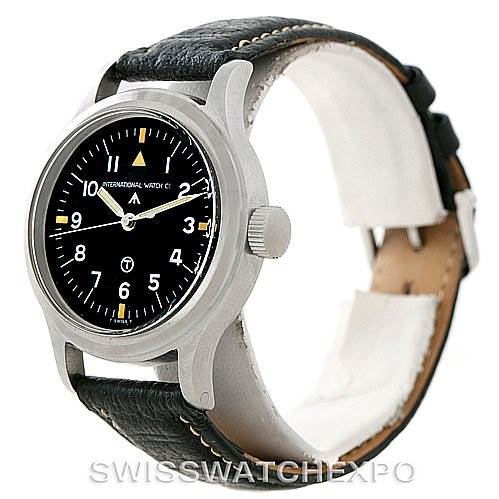 The image shows an IWC Pilot MARK XI Men
s Stainless Steel Black Dial MARK XI Men
s Stainless Steel Black Dial model watch at an angle displaying the face, crown, and part of the black leather strap.