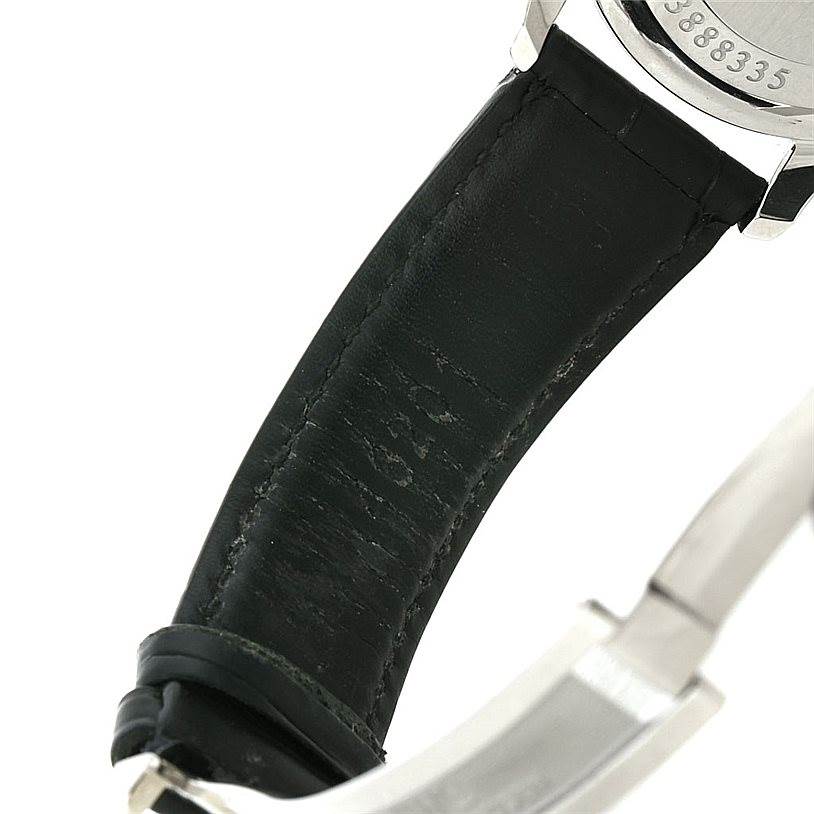 This image shows the backside of the IWC Portuguese IW371446 Men
s Stainless Steel Silver Dial IW371446 Men
s Stainless Steel Silver Dial watch with a partial view of its black leather strap and clasp.