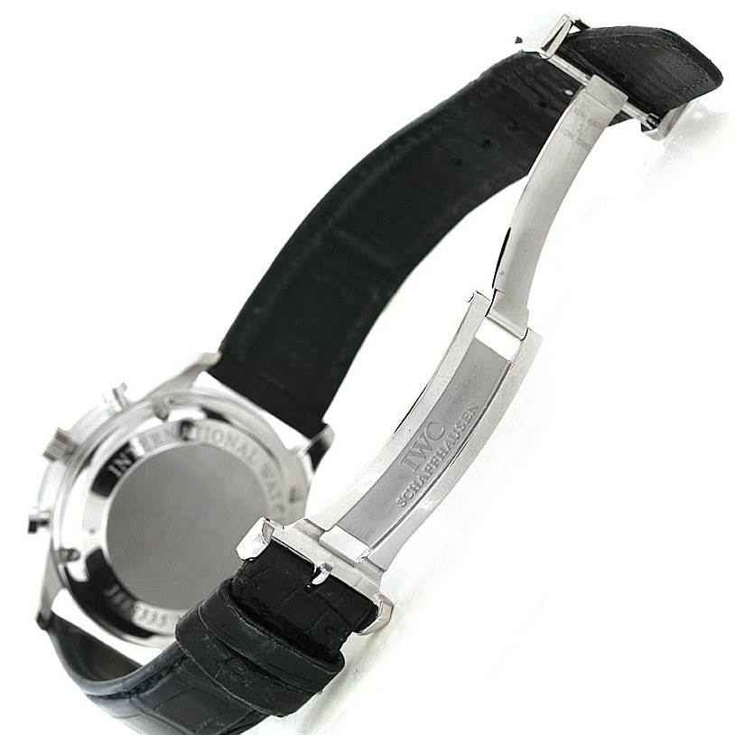 This image shows the back and partially closed clasp of a Portuguese model watch by IWC, highlighting the leather strap and inscription.