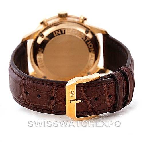The image shows the back view of an IWC Portuguese IW371415 Men's Rose Gold Black Dial IW371415 Men's Rose Gold Black Dial watch with a brown leather strap and the IWC logo on the gold buckle.