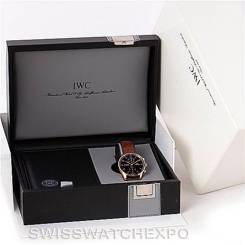 The image shows an IWC Portuguese IW371415 Men's Rose Gold Black Dial IW371415 Men's Rose Gold Black Dial model watch with a brown strap displayed in its open box, along with packaging materials and accessories.