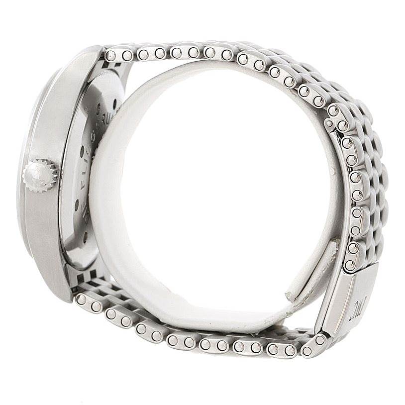 The image shows a side view of the IWC Pilot IW325102 Men's Stainless Steel Black Dial IW325102 Men's Stainless Steel Black Dial watch, highlighting its crown, case back, and metal bracelet.