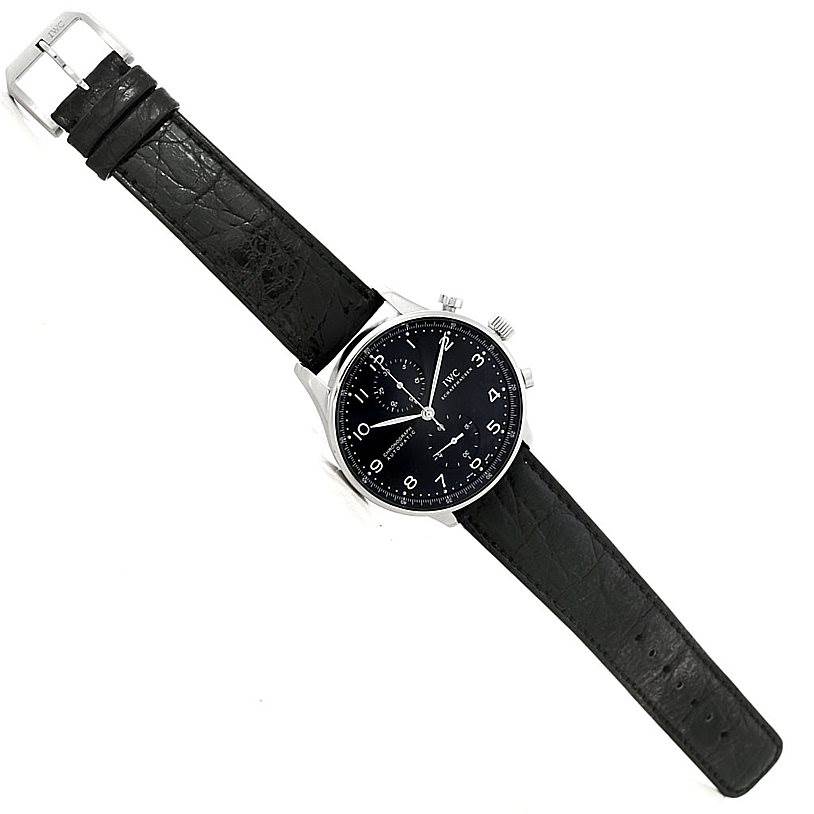 The image shows a full view of an IWC Portuguese IW371438 Men's Stainless Steel Black Dial IW371438 Men's Stainless Steel Black Dial model watch with a black leather strap, silver case, and black dial.