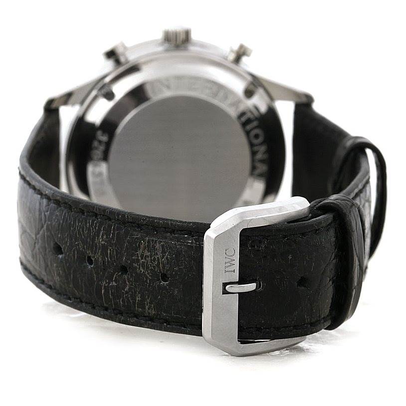 The photo shows the back of the IWC Portuguese IW371438 Men's Stainless Steel Black Dial IW371438 Men's Stainless Steel Black Dial watch and its black leather strap with a clasp.