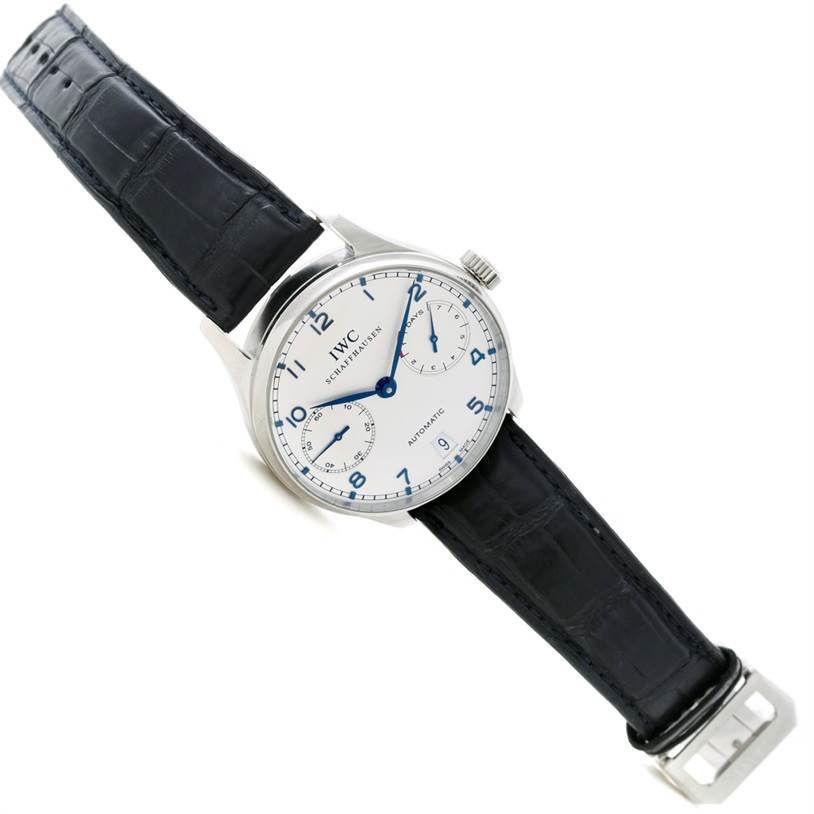 This image shows an IWC Portuguese IW500107 Men's Stainless Steel Silver Dial IW500107 Men's Stainless Steel Silver Dial model watch with a white dial, blue hands, leather strap, and steel case at a slight angle.
