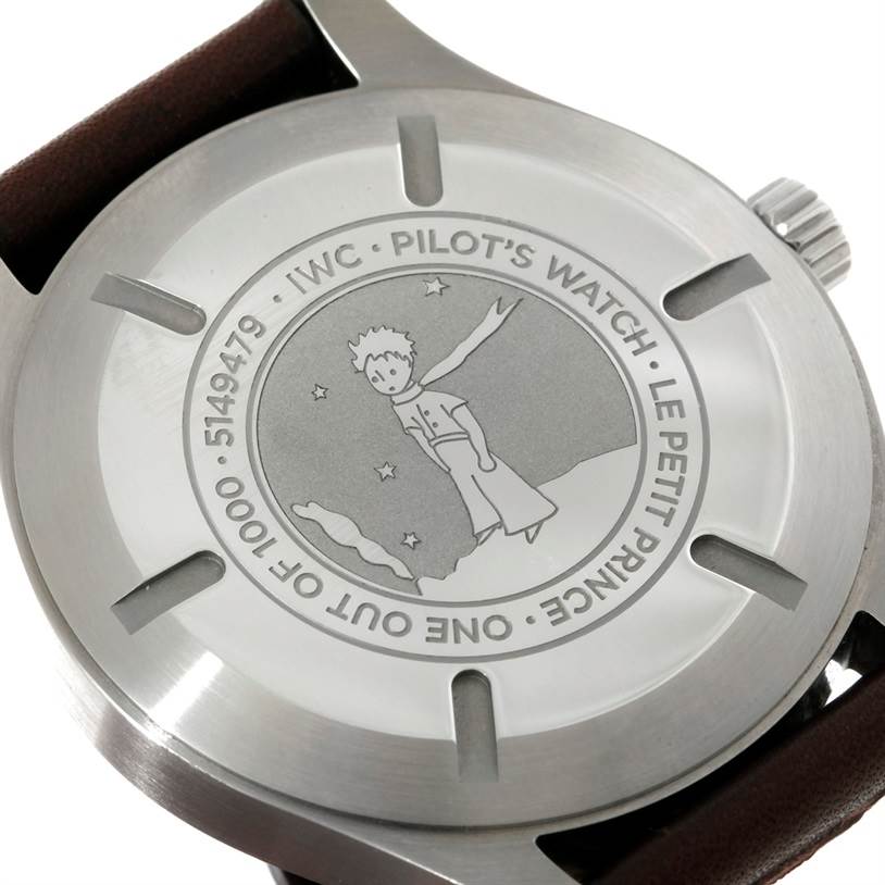 The image shows the engraved case back of an IWC Pilot IW326506 Men's Stainless Steel Blue Dial IW326506 Men's Stainless Steel Blue Dial’s Watch Le Petit Prince model, viewed from a close-up angle.