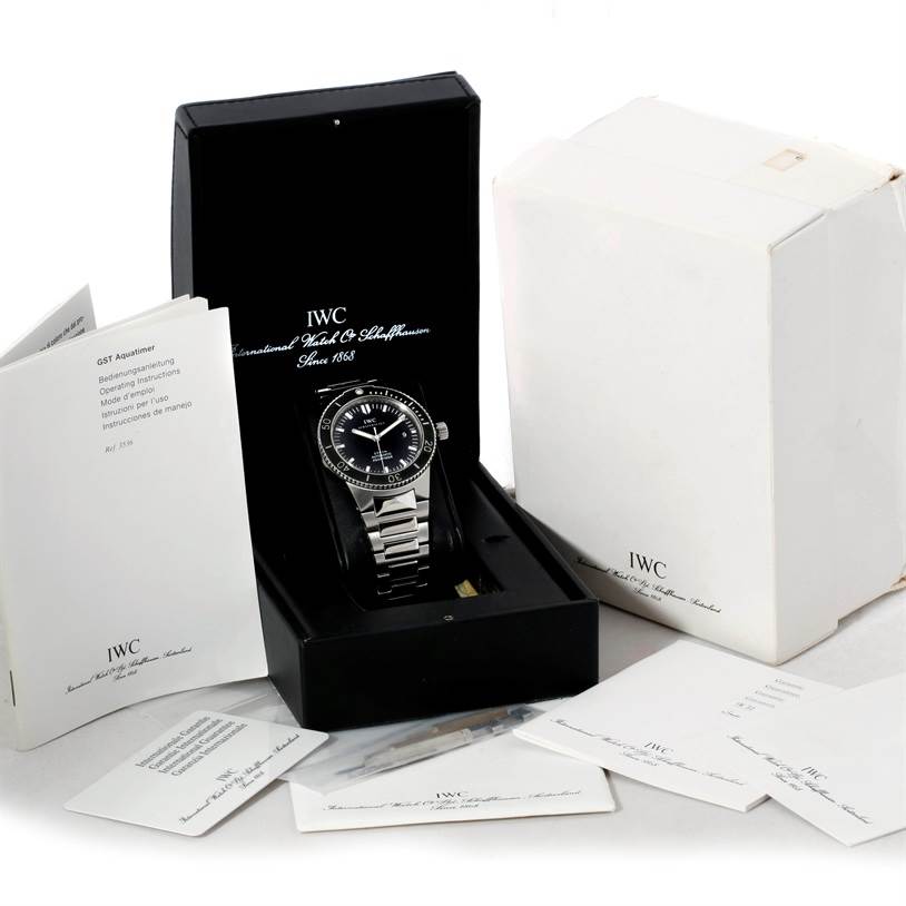 This image shows an IWC GST IW353602 Men's Stainless Steel Black Dial IW353602 Men's Stainless Steel Black Dial model watch in its open box, surrounded by manuals and accessories.