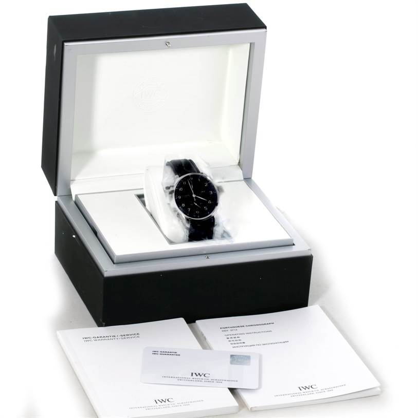 The image shows an IWC Portuguese IW371447 Men's Stainless Steel Black Dial IW371447 Men's Stainless Steel Black Dial model watch in its box along with manuals and warranty card placed in front.
