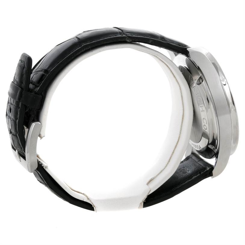 This side view of the IWC Portuguese IW371445 Men's Stainless Steel Silver Dial IW371445 Men's Stainless Steel Silver Dial model shows its case, crown, and black leather strap.