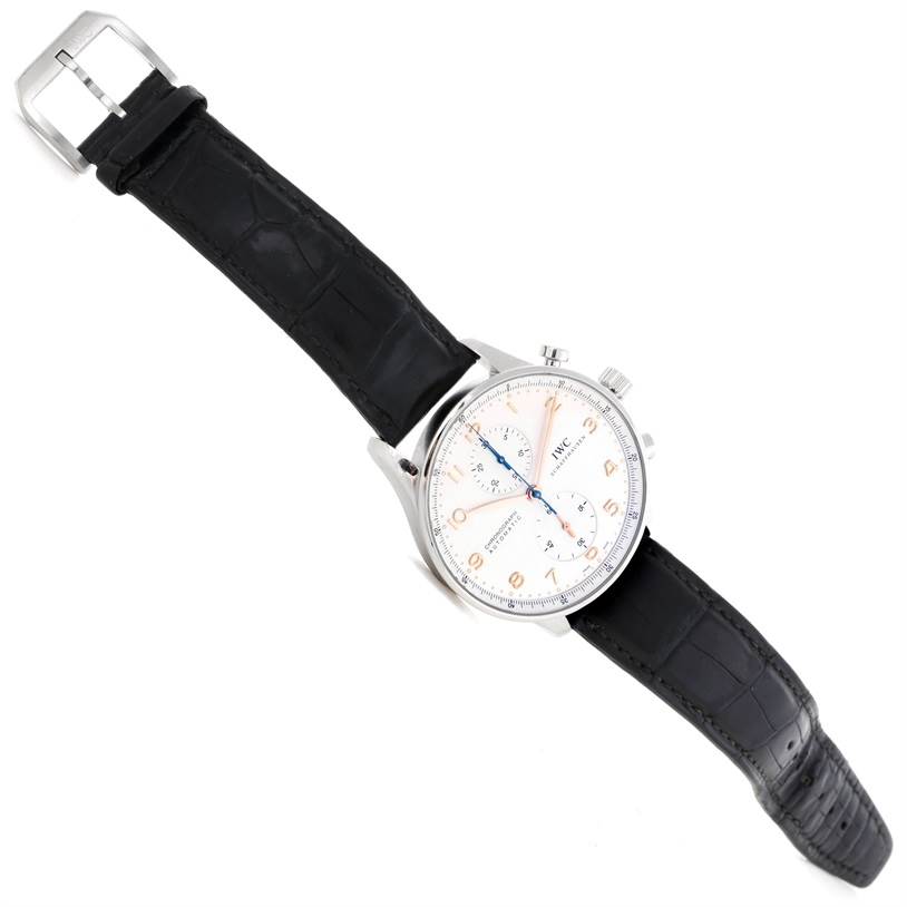 The image shows an angled top-down view of an IWC Portuguese IW371445 Men's Stainless Steel Silver Dial IW371445 Men's Stainless Steel Silver Dial watch, highlighting its face, strap, and buckle.