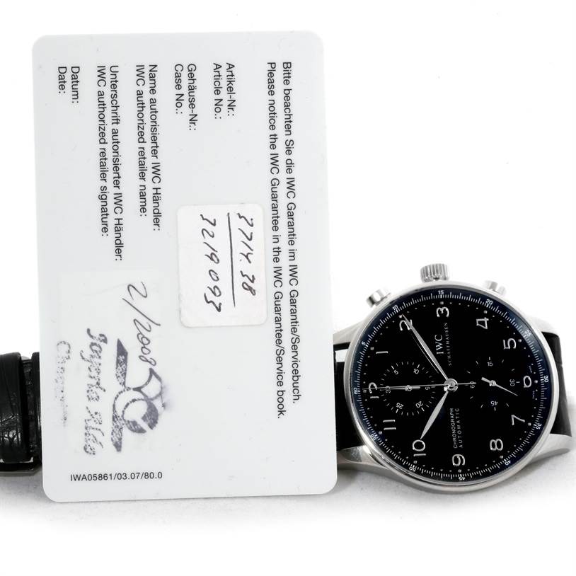 The image shows an IWC Portuguese IW371438 Men's Stainless Steel Black Dial IW371438 Men's Stainless Steel Black Dial model watch from the front, displaying its face and also accompanied by its warranty card.